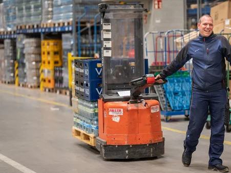 A logistics employee at the Europa-Park Resort. He transports goods using an industrial truck.