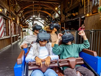 Fahrgäste mit VR-Headset sitzen in der Attraktion Alpenexpress Coastiality.